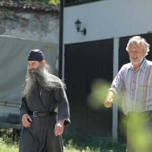 Meda with monk in the churchyard