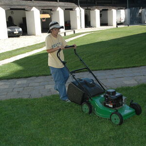 Stefan helps with mowing the grass in the churchyard