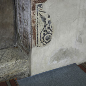 Stone doorstep of the west enrance into the nave and segment of the painted dado