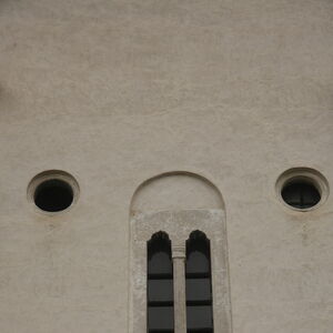 Mullioned window (bifora) and two oculi on the western facade of church