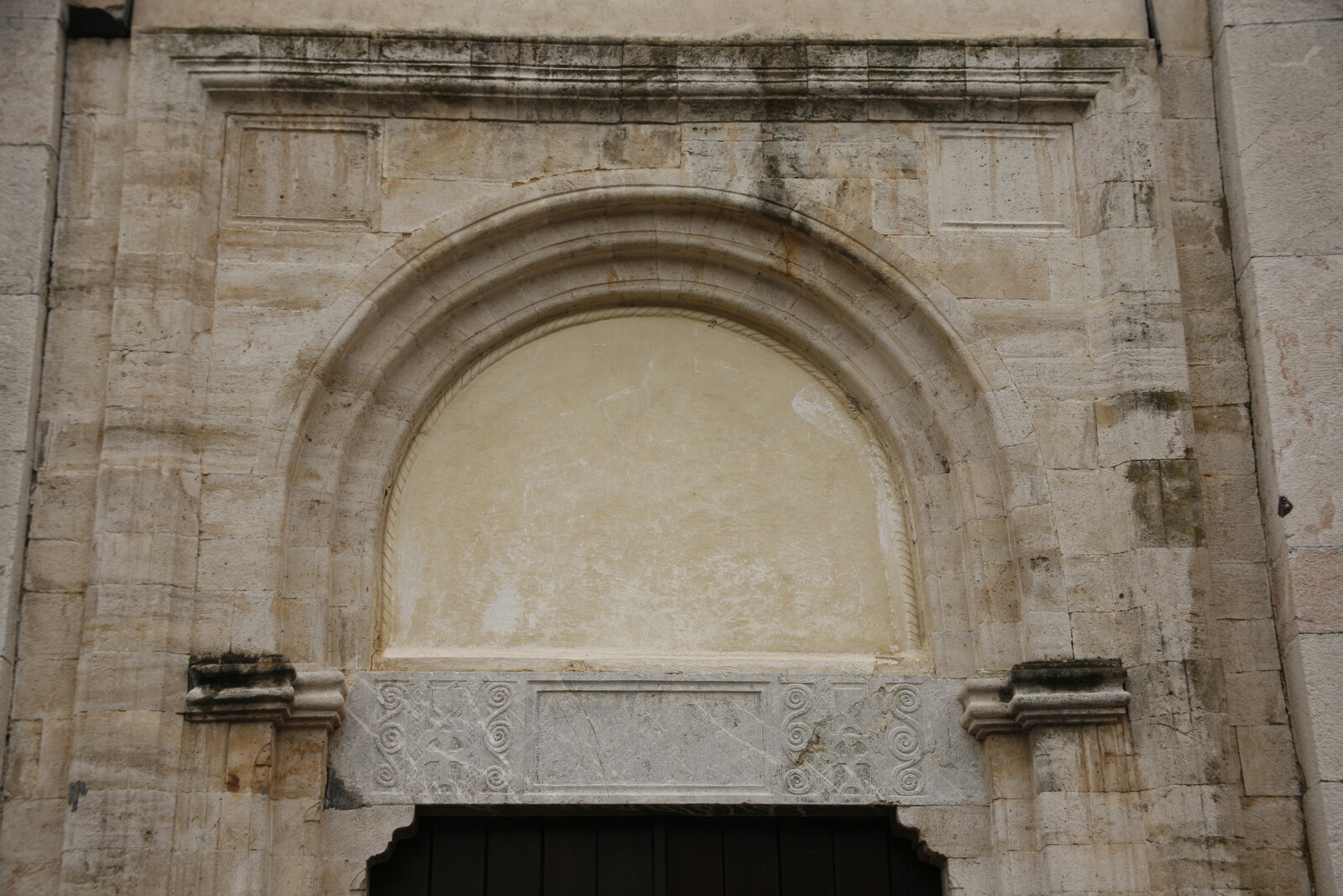 Architrave and lunette of the western portal of church