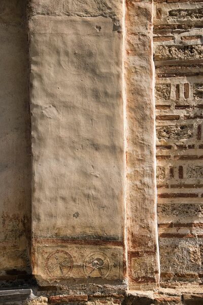 Pilaster with remains of a faded standing figure