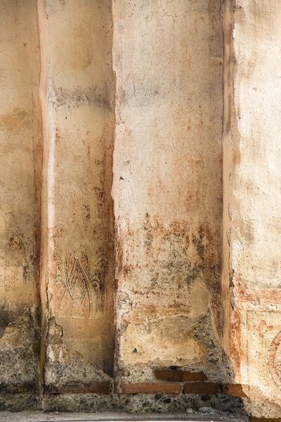 Remains of standing figures and ornaments below