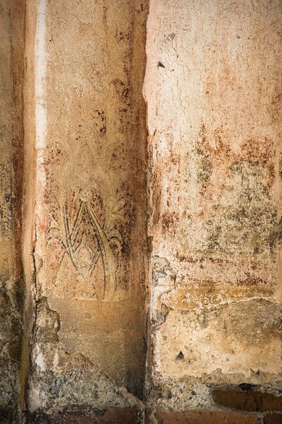 Remains of standing figures and ornaments below