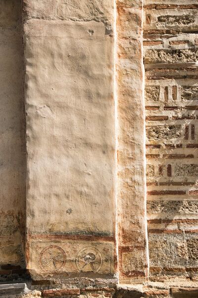 Pilaster with remains of a faded standing figure
