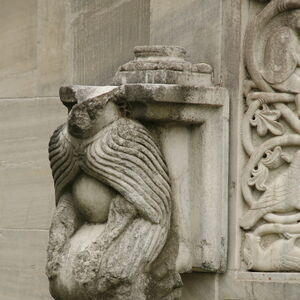 Kneeling figure on the south side of the window