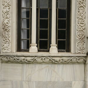 Bottom frame of the window with two kneeling figures